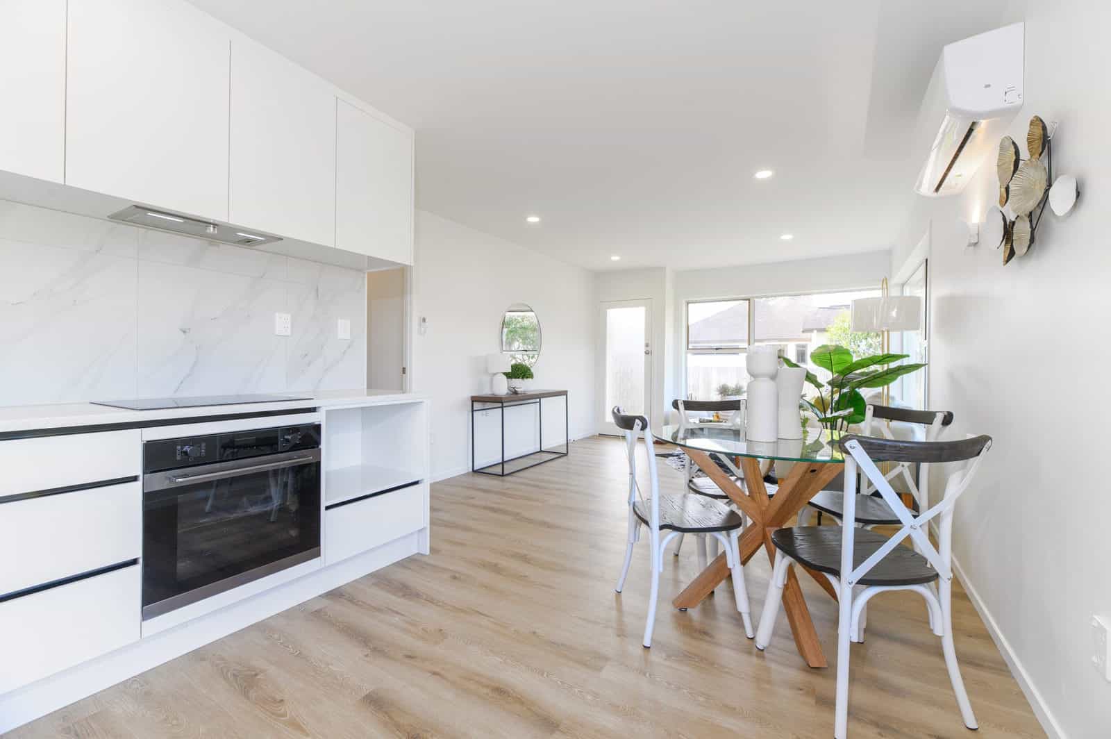Renovated kitchen with a marble-look splashback and a dining table alongside, Milford