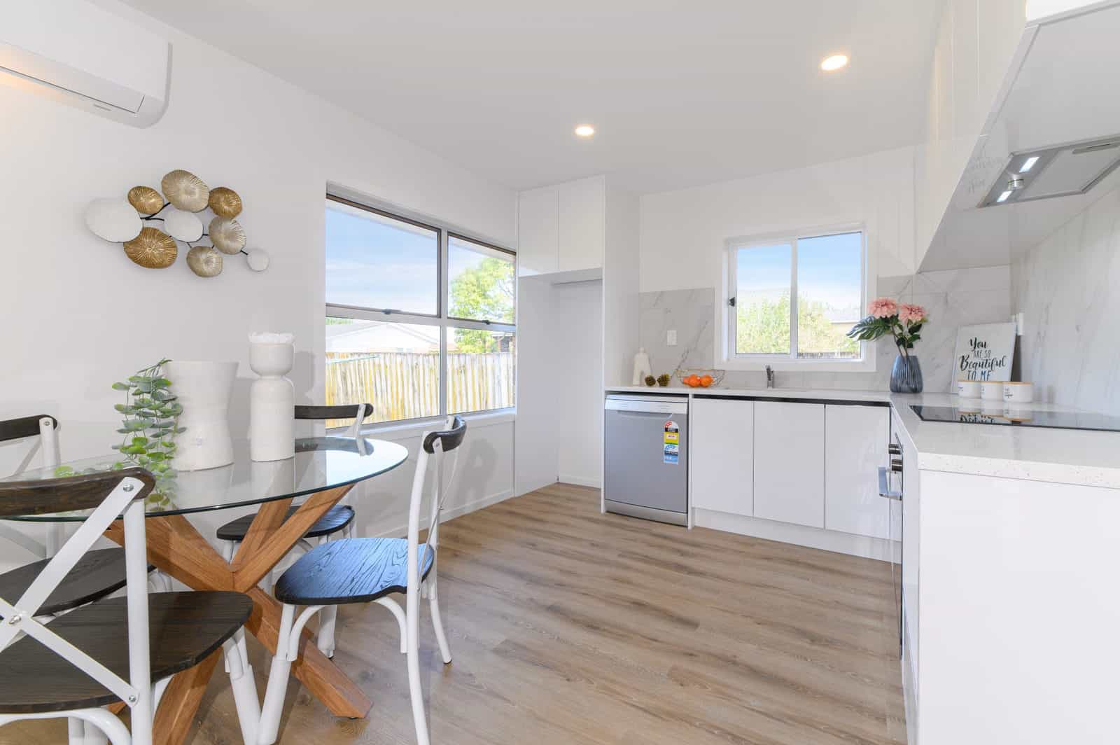 Kitchen and dining with a window above the bench and a heat pump, Milford