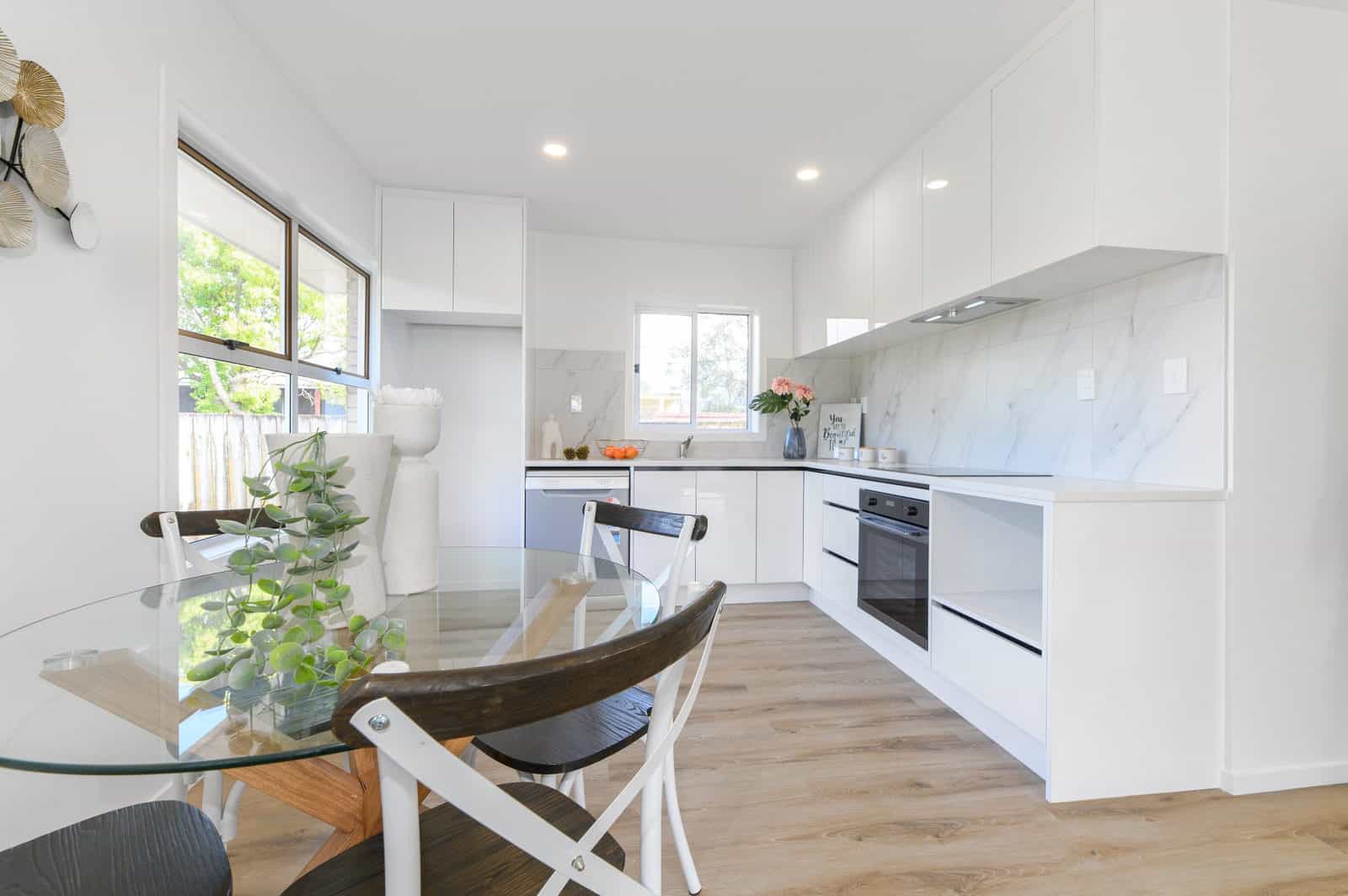 Renovated galley kitchen with a wall oven and marble-look splashback, Milford