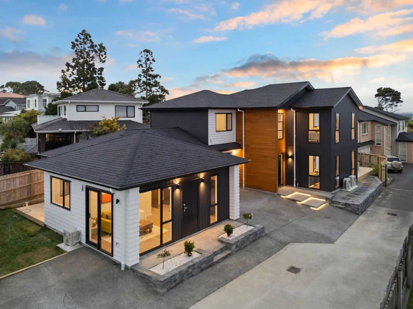 Aerial of the two dwellings and their shared drive at dusk, New Lynn