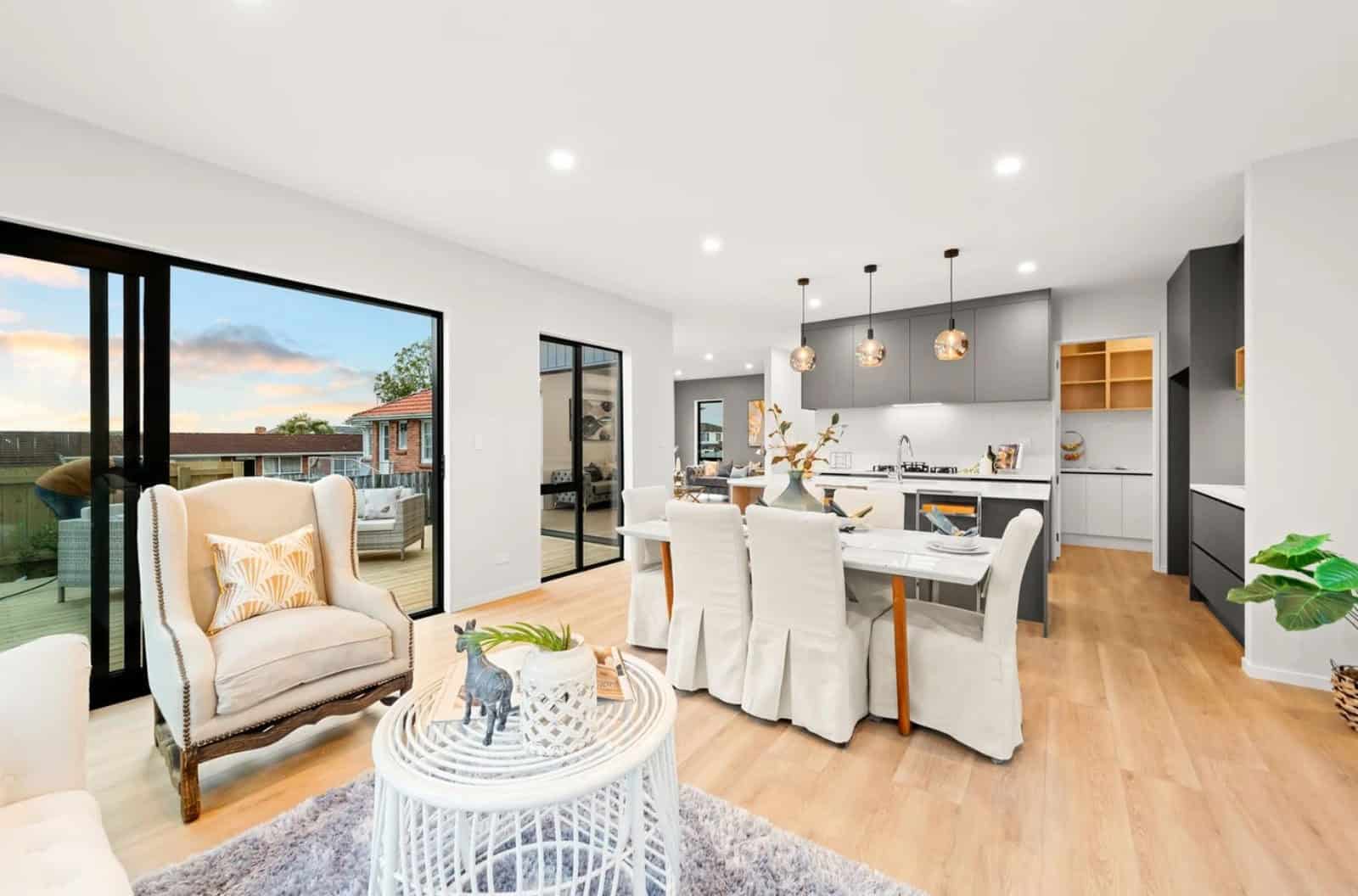 Living and dining with a kitchen island beyond and sliding doors to the garden, New Lynn