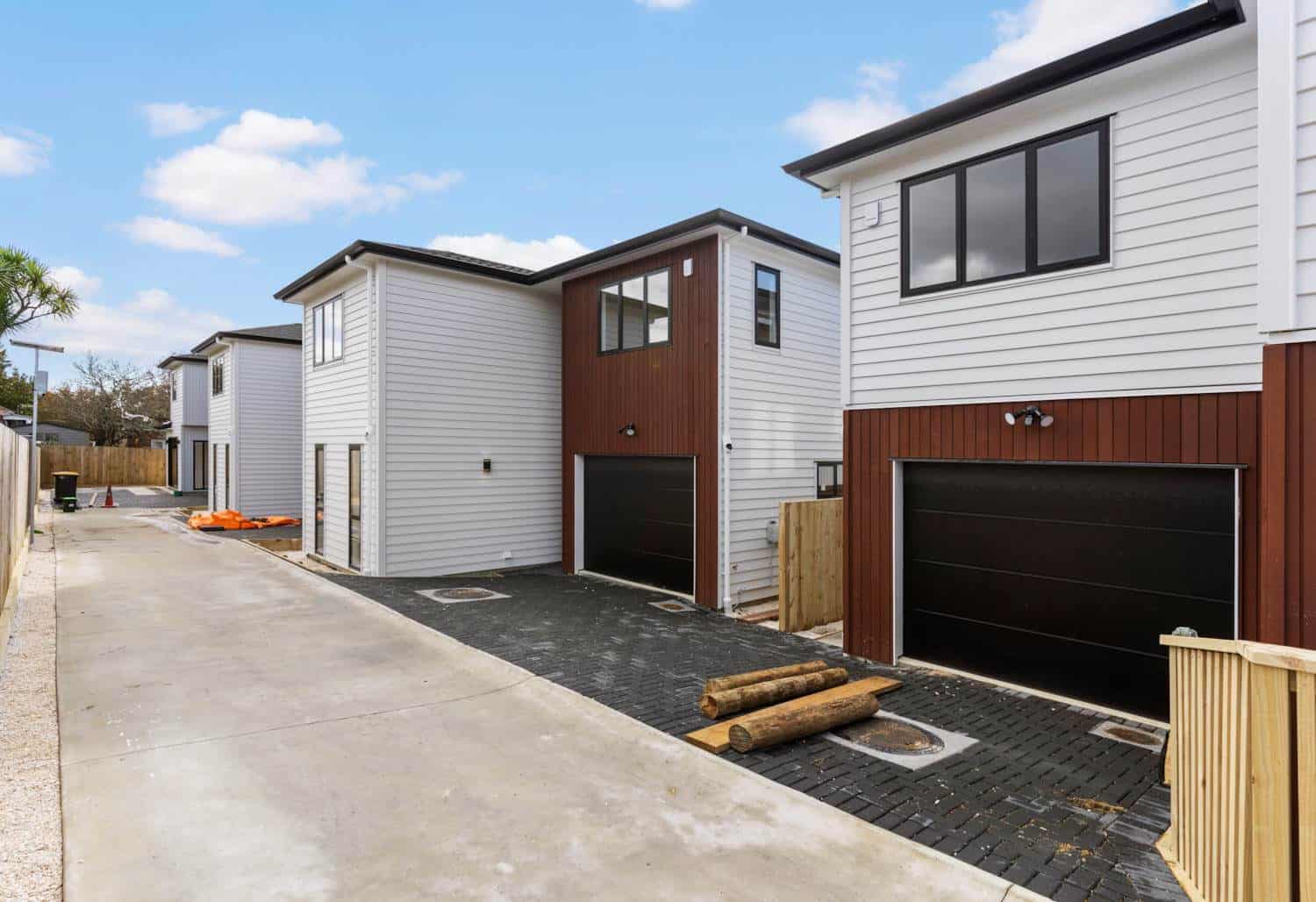 New two-storey houses along a shared paved drive, New Lynn