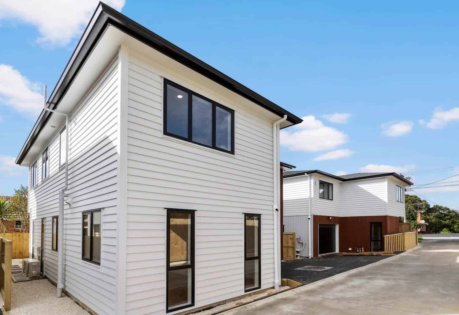 Corner of a new weatherboard house with the drive running past, New Lynn