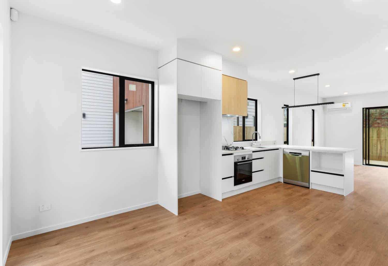 Kitchen with white cabinetry, a wall oven and a peninsula bench, New Lynn