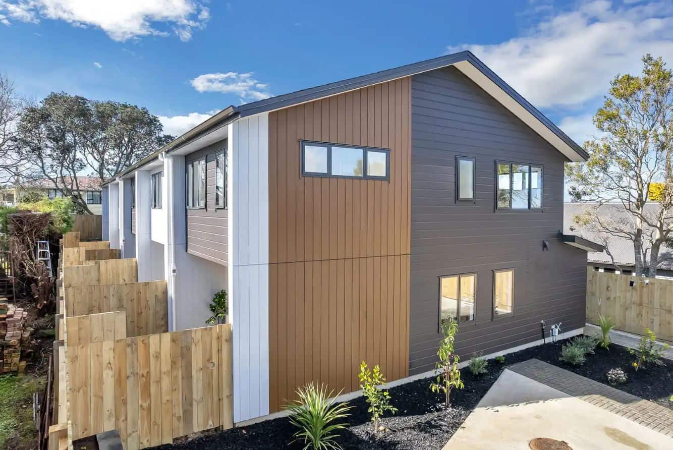 Terraced house in timber and white cladding beside a retaining wall, New Windsor