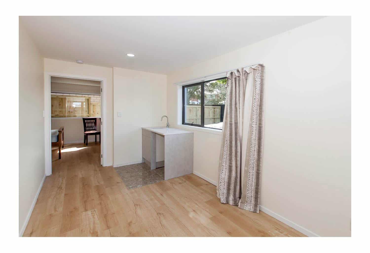 Renovated room with a peninsula bench looking through to the dining area, New Windsor