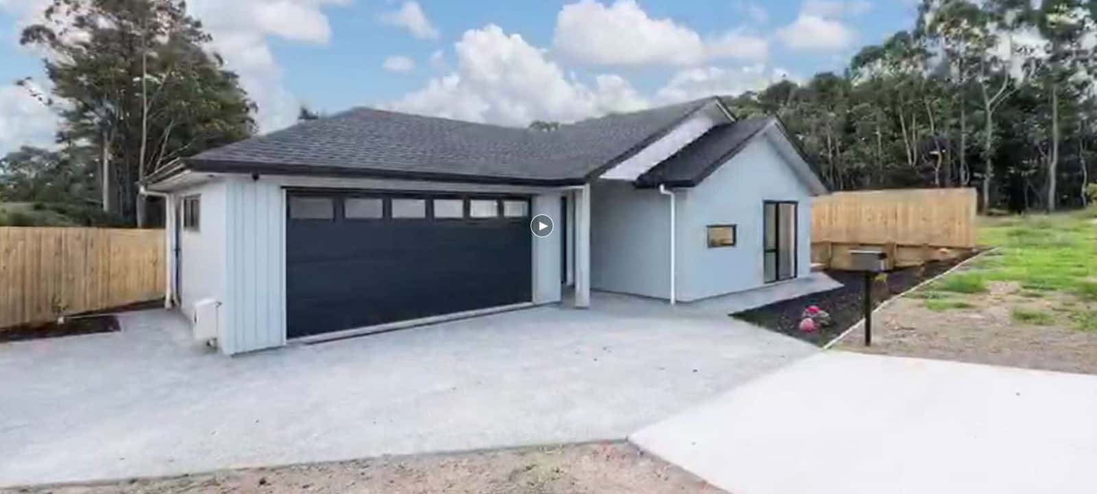Single-level house with a double garage and a paved drive, Orewa