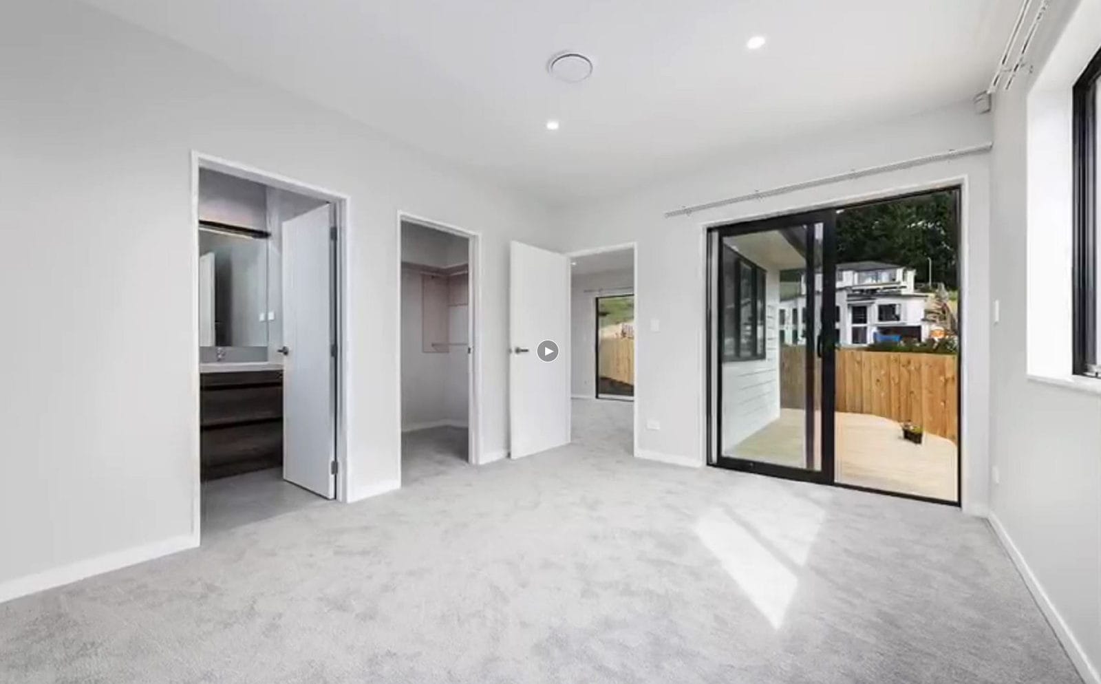 Empty bedroom with an ensuite alongside and a sliding door to the deck, Orewa