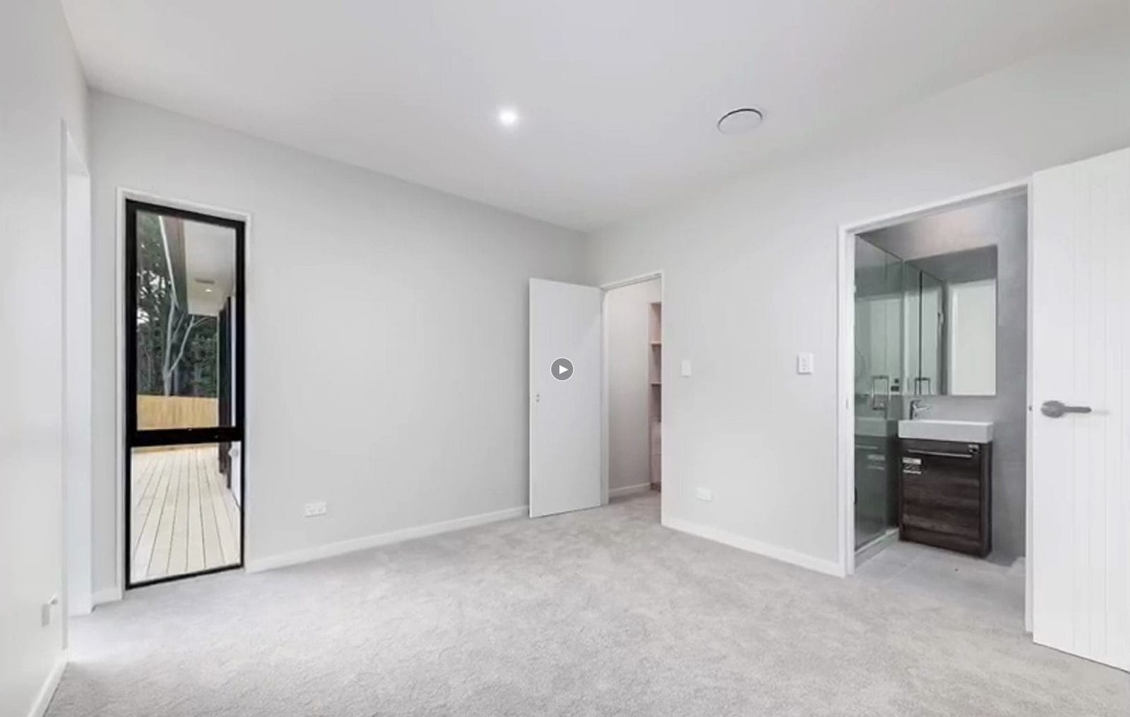 Empty bedroom with a window, wardrobe and an ensuite through the doorway, Orewa