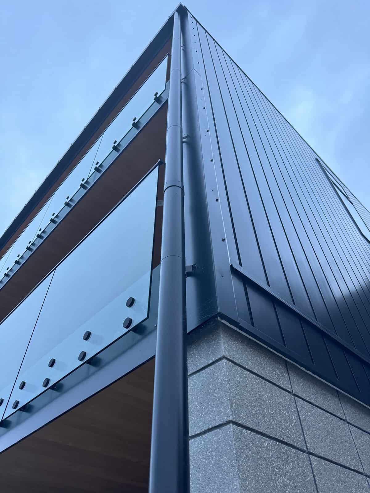 Close-up of the standing-seam cladding and glass balustrade detail, Red Beach