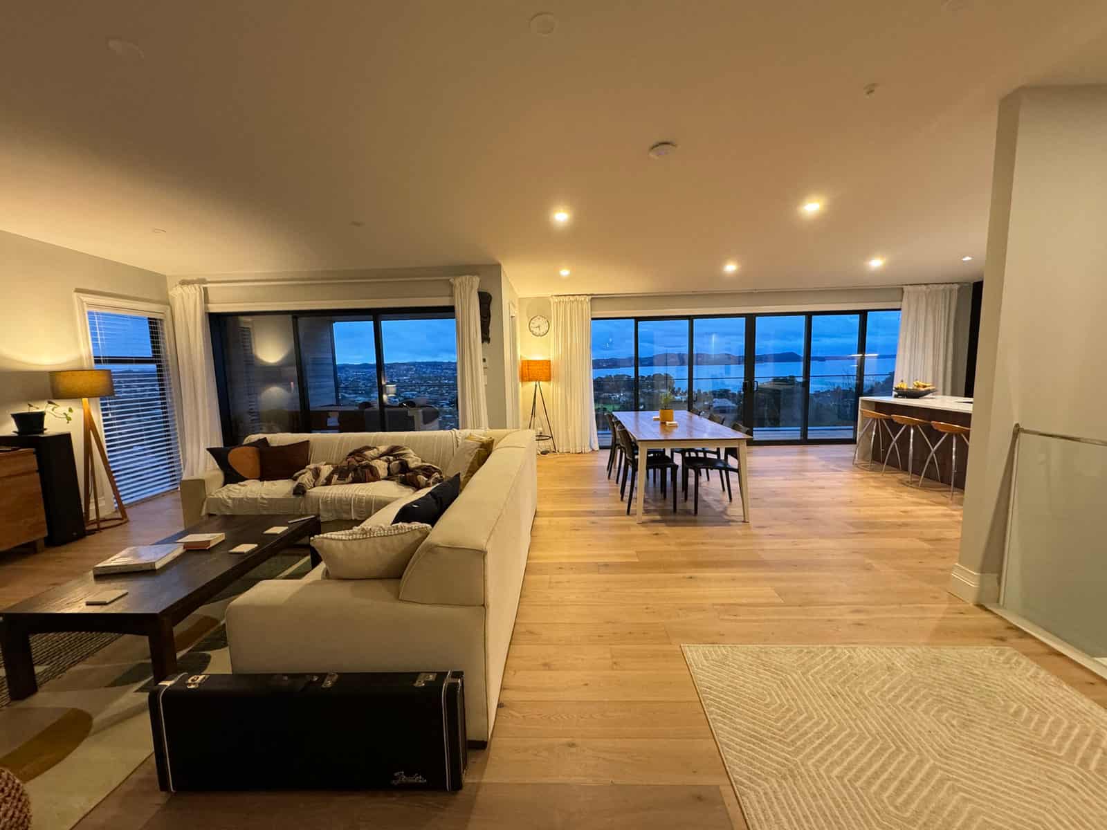 Open-plan living and dining with the view through the corner windows, Red Beach