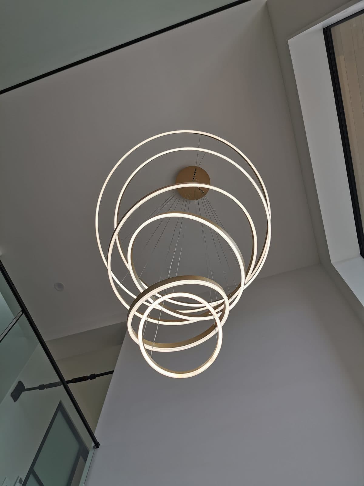 Sculptural ring pendant hanging in the double-height stairwell, Silverdale