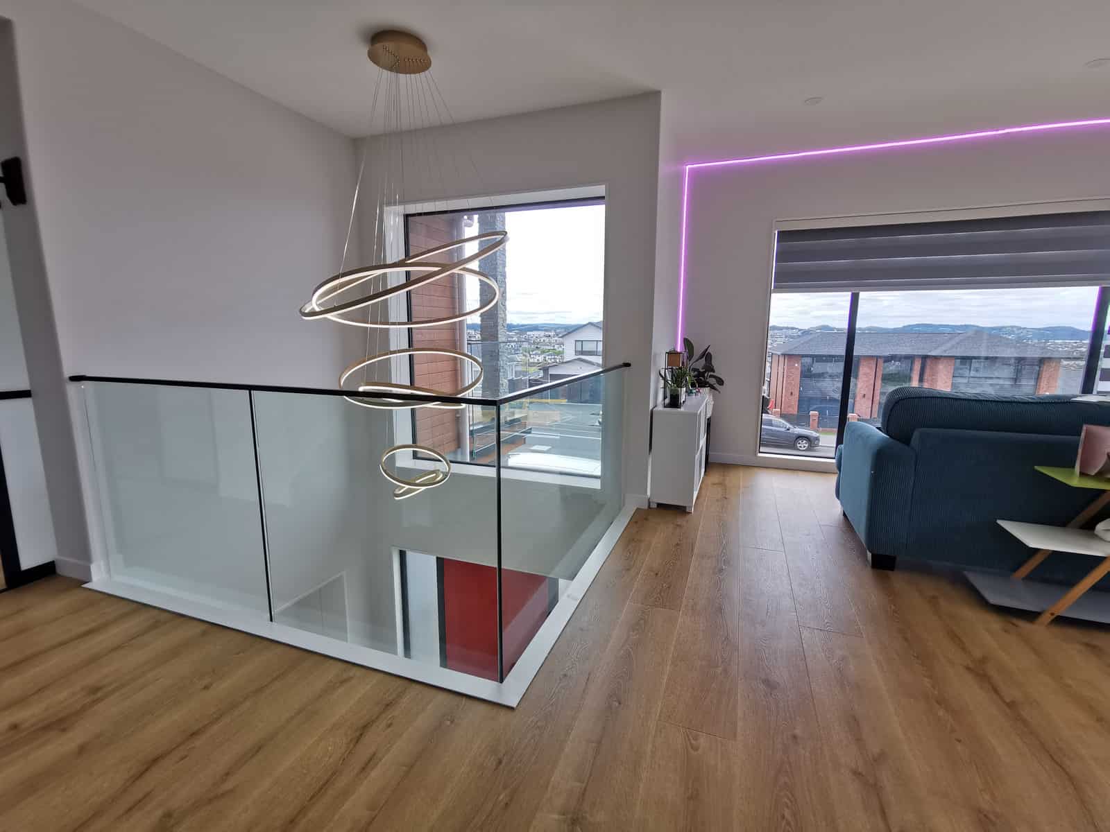 Upper living area with concealed LED lighting and a glass balustrade, Silverdale