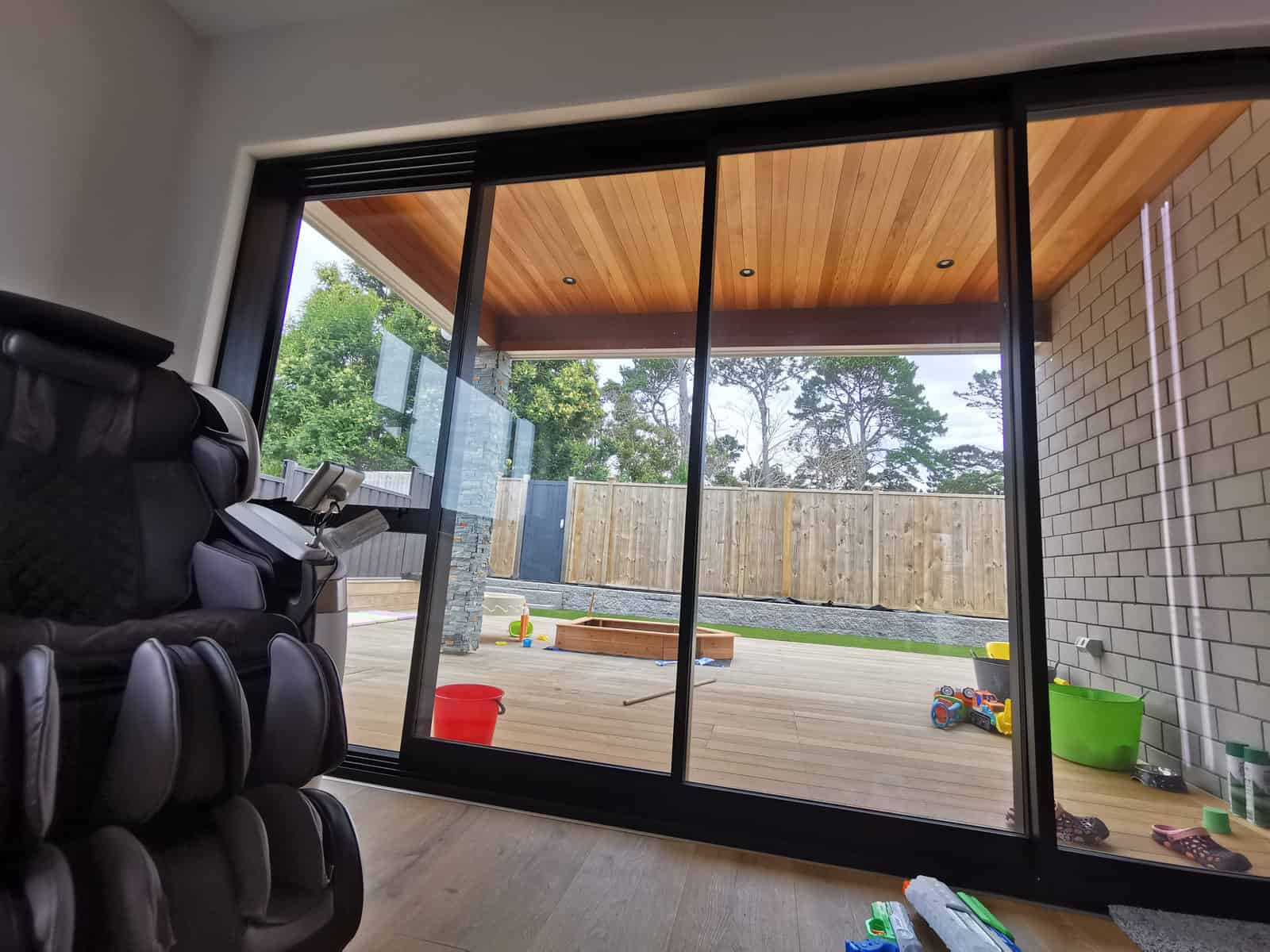 Sliding doors opening onto a covered deck with a timber-lined soffit, Silverdale