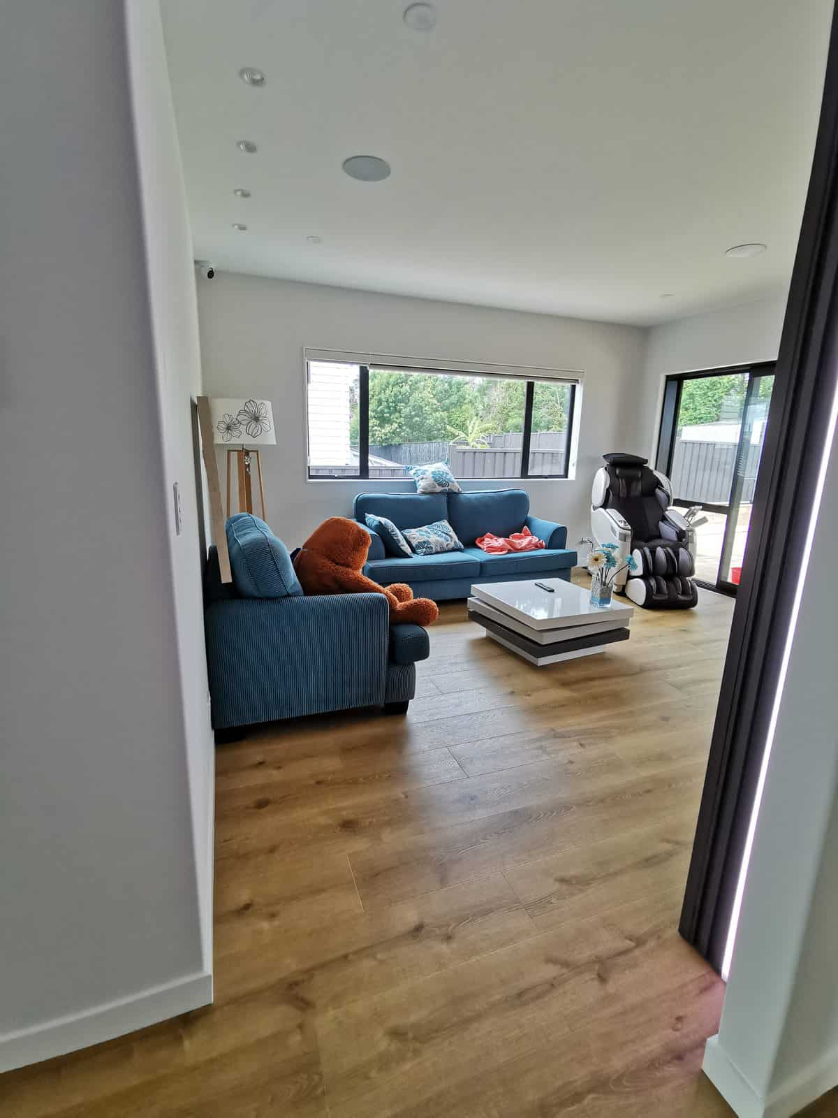 Living room with a blue sofa and a wide window, Silverdale
