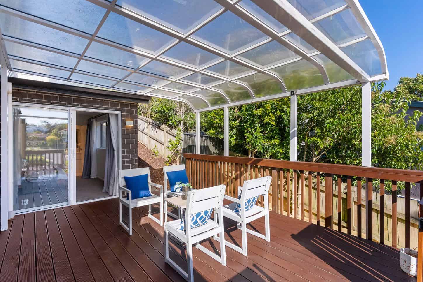 Deck under a curved clear roof with outdoor chairs, Sunnynook