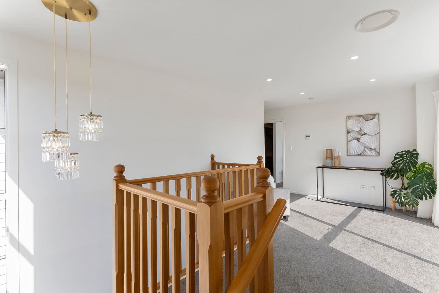 Upper landing with a timber balustrade and cluster pendant lights, Sunnynook