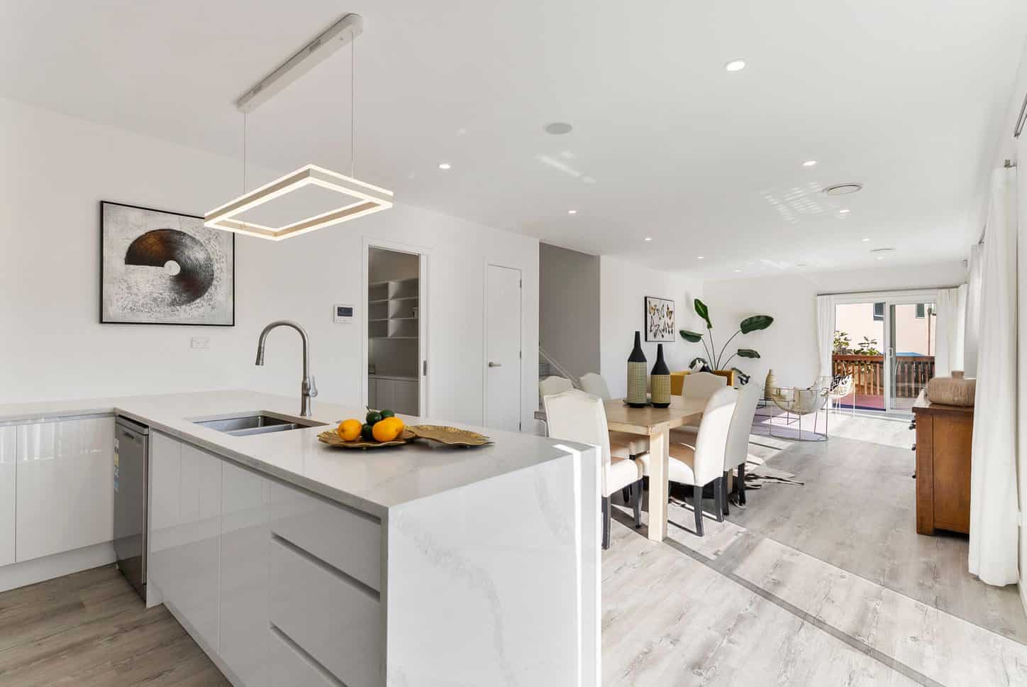 Kitchen island with a linear pendant and the dining table beyond, Sunnynook