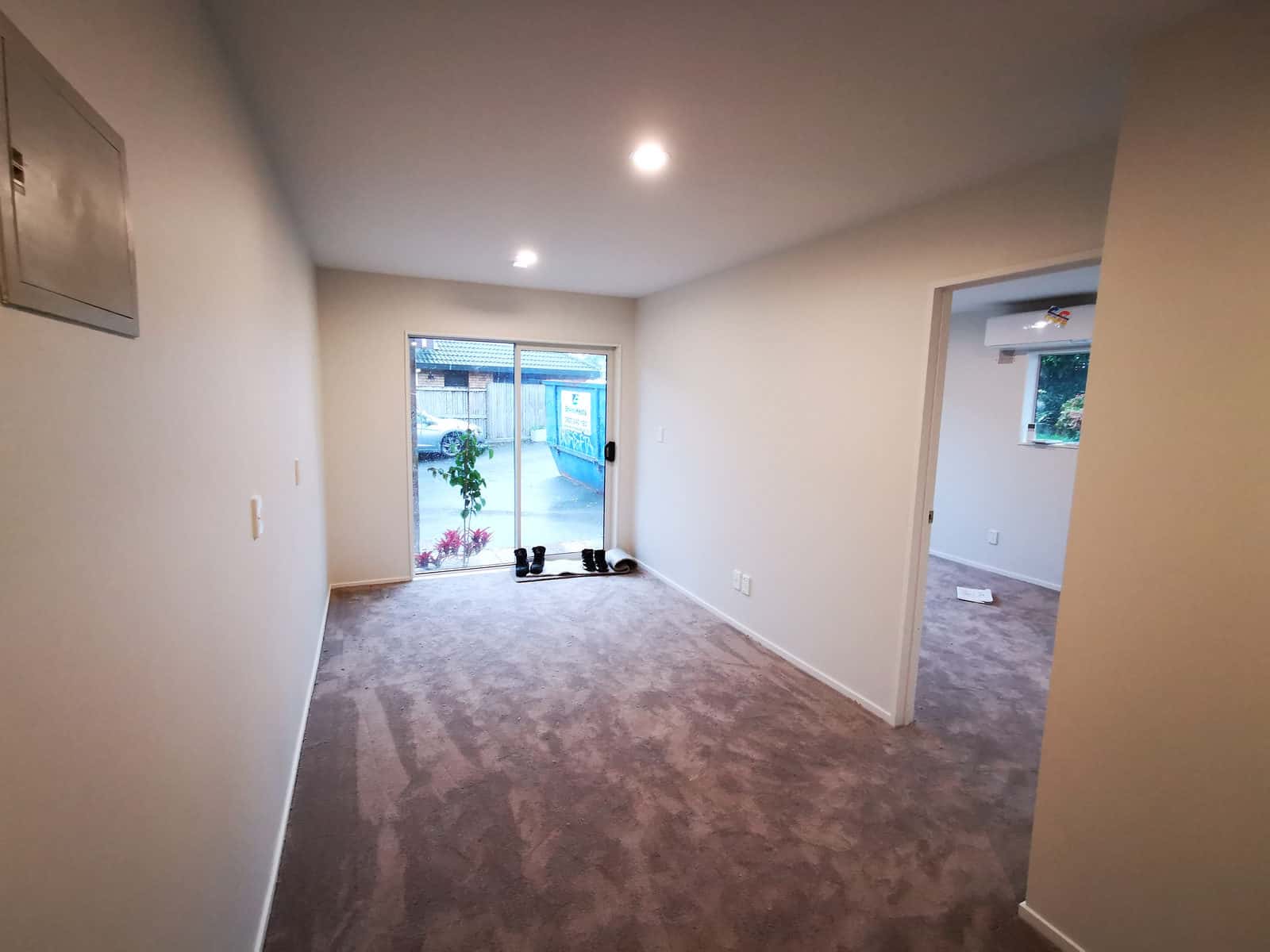 Converted garage room looking back to the sliding door and entry, The Gardens