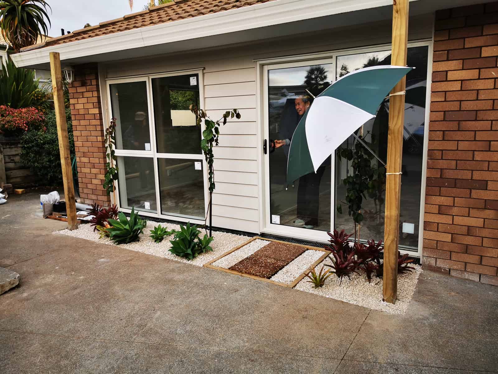 Converted garage from the driveway with new glazing and planting, The Gardens