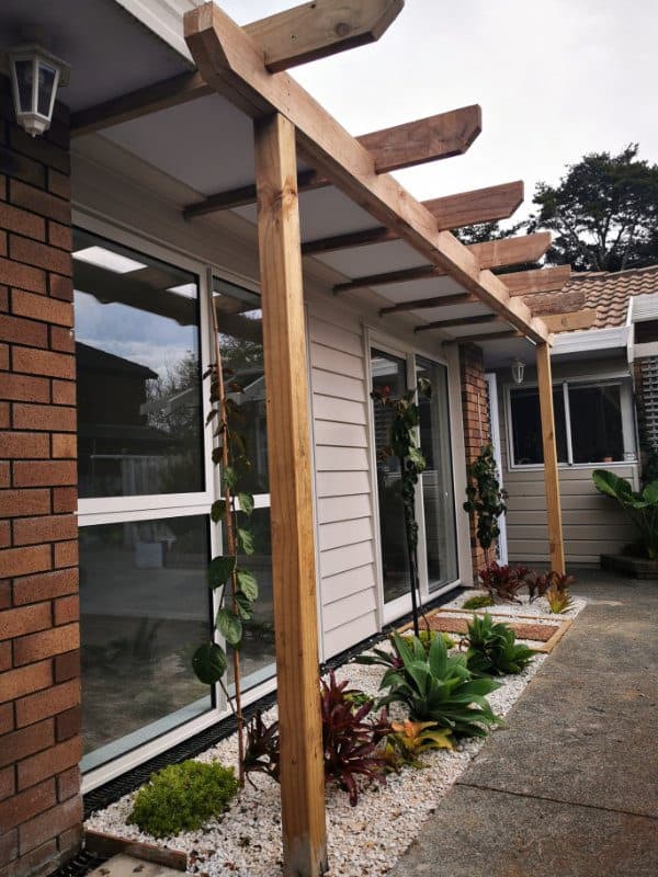 Timber pergola running along the converted garage with new planting below, The Gardens