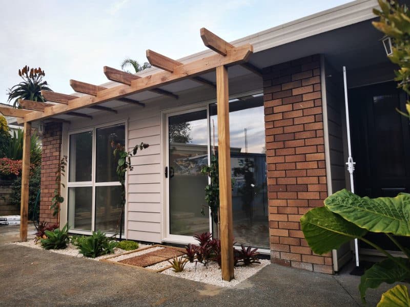 Pergola posts and new glazing along the converted garage elevation, The Gardens