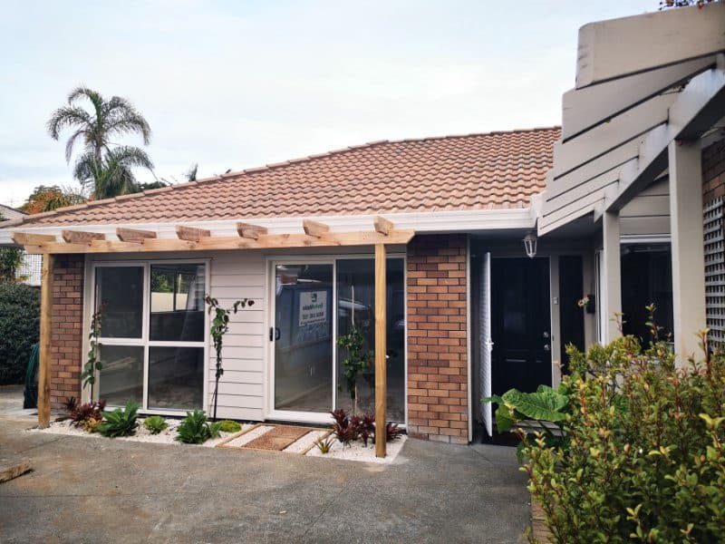 Converted garage and pergola seen from the driveway with the house alongside, The Gardens