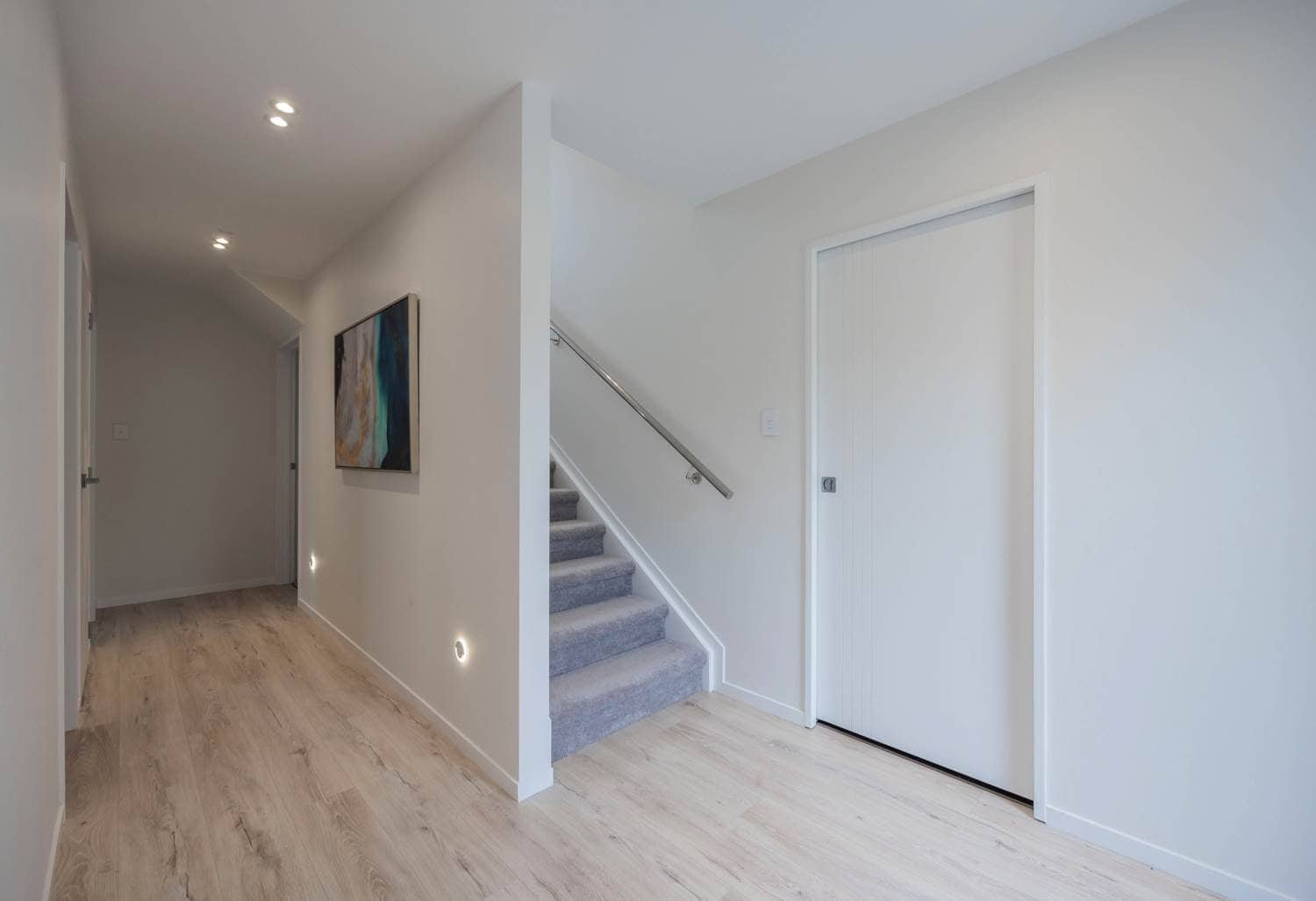 Hallway with the stair rising beside it and a door to the garage, Torbay