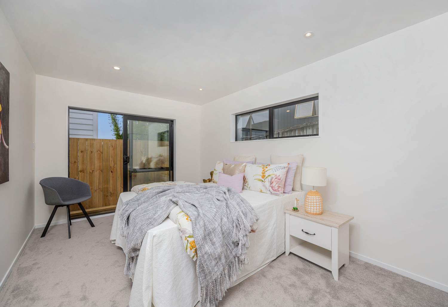 Bedroom with a sliding door to the courtyard and a high horizontal window, Torbay