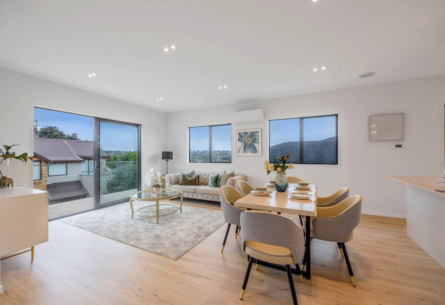 Open-plan living and dining with sliding doors and a bush outlook, Torbay
